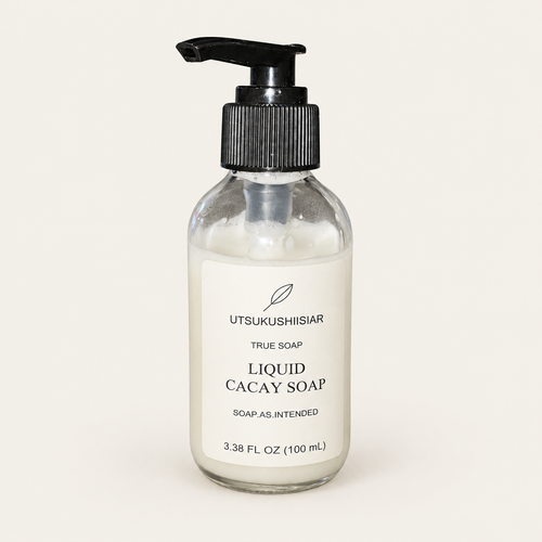 Liquid Cacay Soap, 100 mL clear glass bottle with black pump on a warm off-white background